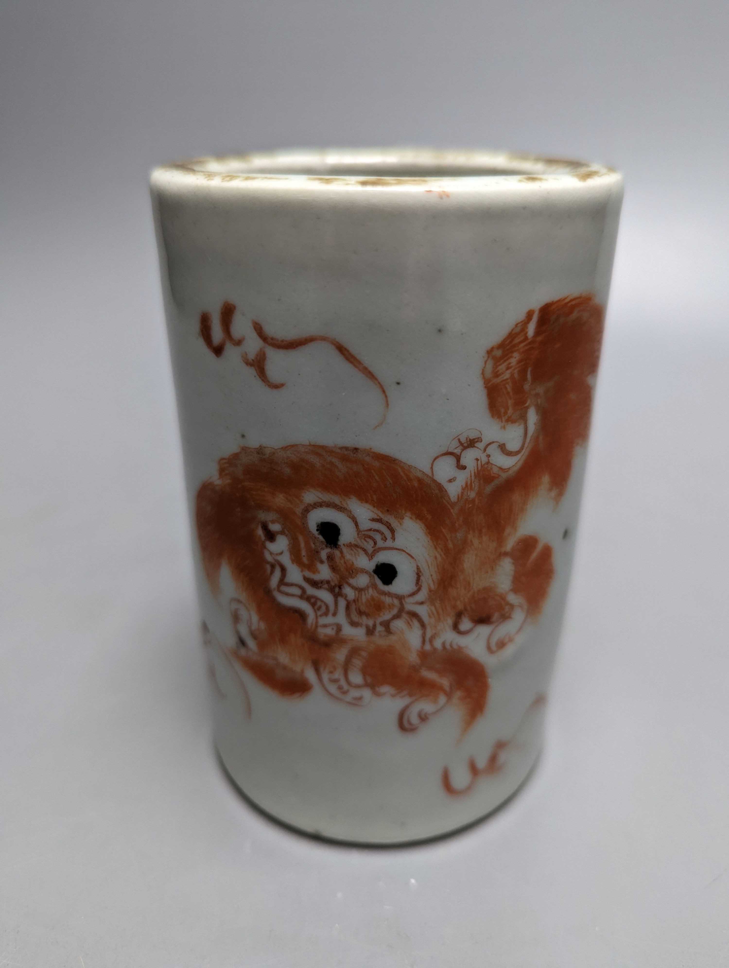 An early 20th century iron red enamelled 'lion' brush pot 12cm